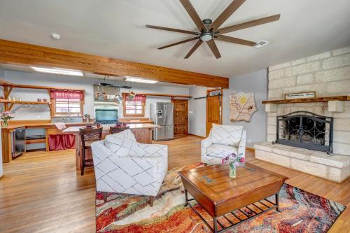 a living room with a fireplace and a table at Full Moon Inn in Fredericksburg