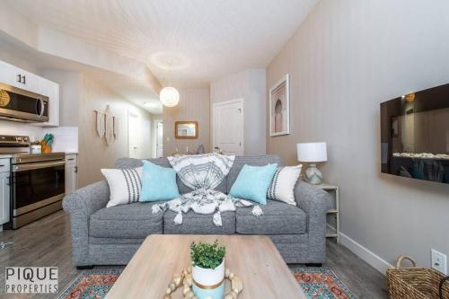 a living room with a couch and a table at Boho Suite - Long Stays - King Bed - Fireplace & WiFi in Edmonton