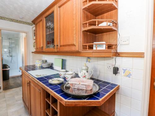 a kitchen with a counter with a cake on it at Appletree Cottage in Richmond