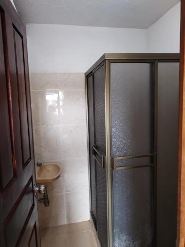 a bathroom with a shower and a sink at Divino Niño Hotel in Leticia