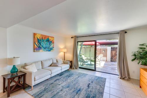 a living room with a white couch and sliding glass doors at 1 Mi to Old Town! Snowbird Escape with Pool Access in Scottsdale