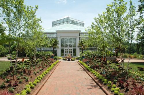 a building with a pathway in front of a garden at Fairfield Inn & Suites Charlotte Arrowood in Charlotte
