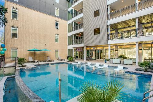 a large swimming pool in a building with a hotel at Radiant condo on the Riverwalk 1325 in San Antonio