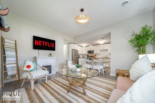 a living room with a table and a kitchen at BoHo Chic Suite - Long Stays - Fireplace - Garage in Edmonton