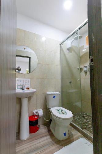 a bathroom with a toilet and a glass shower at MINCA Chunuu - glamping - coworking MINCA in Minca