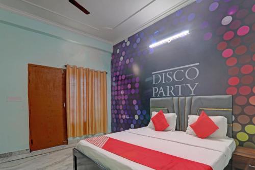 a bedroom with a bed with a disco party wall at Super OYO Flagship Siddharth Inn in Lucknow