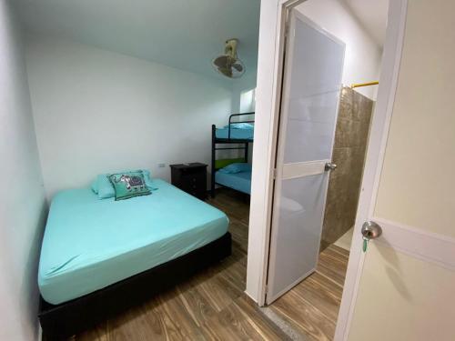a small room with a bed and a closet at Casa ISABELLA - Playa dormida in Santa Marta