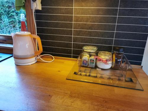 a shelf with jars on a table next to a blender at Bubbles Breakfast and Spa in Sandefjord