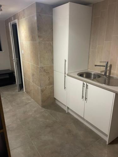 a bathroom with a sink and a shower at 50A Green Lane in Cranford