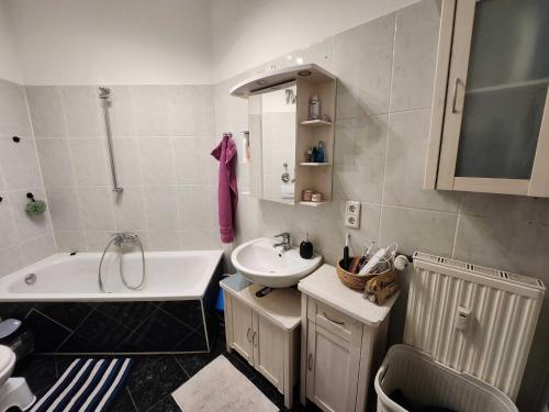 a bathroom with a sink and a bath tub and a sink at One Private room available in a two room apartment in Tegel, Berlin in Berlin