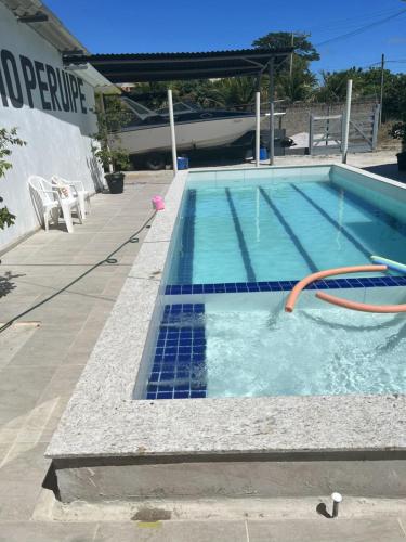 a swimming pool with blue tiles on the side of a building at POUSADA RIO PERUYPE in Nova Viçosa