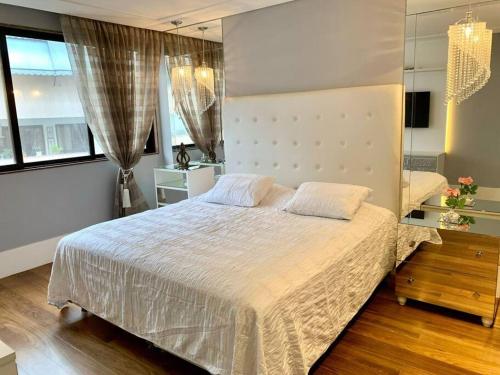 1 dormitorio con cama grande y ventana grande en Apartamento na quadra da praia en Río de Janeiro