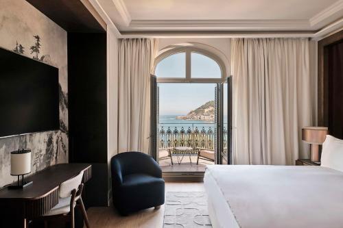 a hotel room with a bed and a large window at Nobu Hotel San Sebastián in San Sebastián