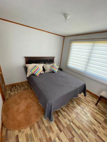 a bedroom with a bed with two pillows on it at cabañas san antonio in Los Ángeles