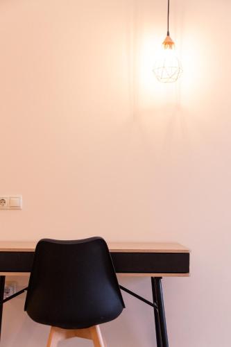 a black chair sitting in front of a desk at Mini Suites Near Athen's Airport Free Shuttle From and to Athen's Airport in Spáta