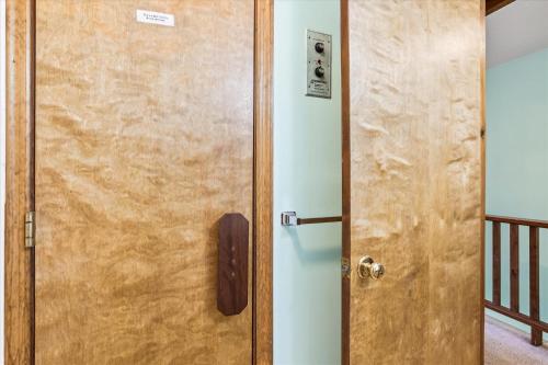 a wooden door with a telephone next to a room at Two bedroom Townhouse within walking distance to all activities Glazebrook J4 in Killington