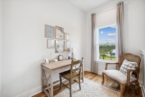a desk in a room with a chair and a window at Emerald Oasis at Laguna Haven in Panama City Beach