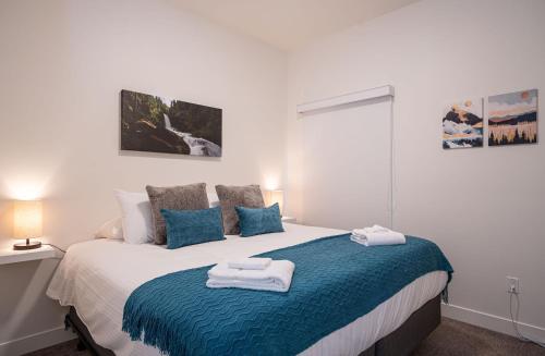 a bedroom with a bed with towels on it at Peak Paradise by Revelstoke Vacations in Revelstoke