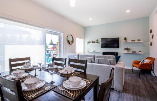 a living room with a table and chairs and a couch at Peak Paradise by Revelstoke Vacations in Revelstoke