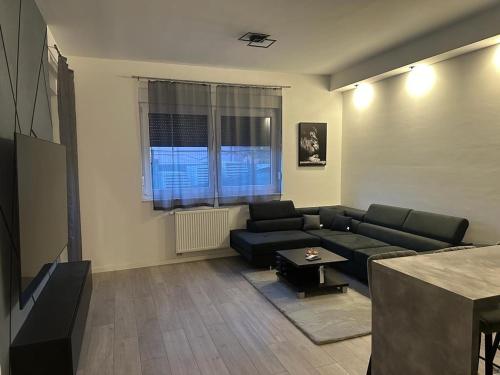 a living room with a couch and a table at Apartment Black and white in Zagreb