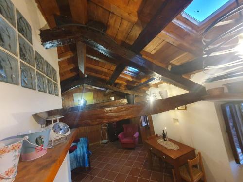 a kitchen with wooden ceilings and a wooden table at Casa Puggimiano in Poggio Moiano