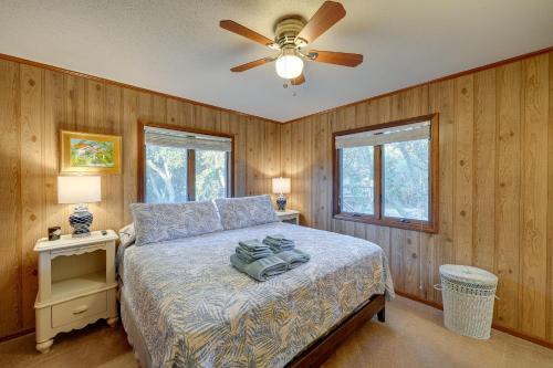 a bedroom with a bed with a ceiling fan at Outer Banks Retreat - Walk to Beach! in Southern Shores
