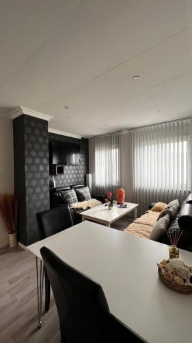 a living room with a table and a couch at Face Of North in Gratangen
