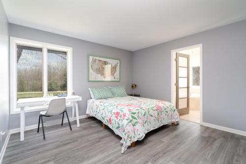 a bedroom with a bed and a desk and a window at Riverfront Inn in Red Wing