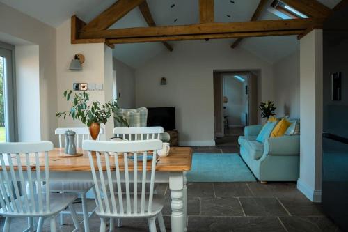 a living room with a table and chairs at The Stables, converted barn outside York in York