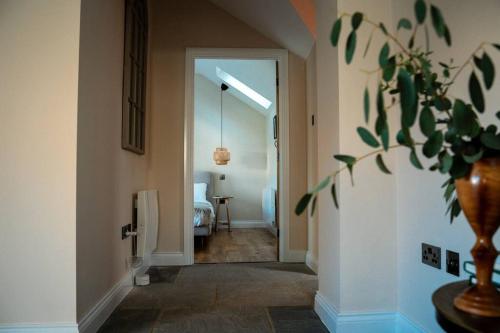 a hallway with a door leading to a bedroom at The Stables, converted barn outside York in York