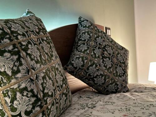 two pillows sitting on top of a bed at B&B Le Chicche di Lulu' in Borghetto