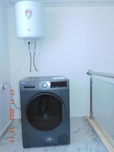 a washing machine sitting in a room with a dryer at Villa avec Piscine Privée. in Saidia 