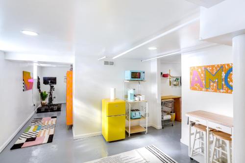 a kitchen with a yellow refrigerator in a room at Gordon Square Studio about 4 Mi to Downtown Cleveland! in Cleveland