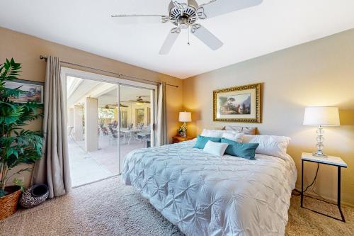 um quarto com uma cama e uma ventoinha de tecto em Pink Bloom Sanctuary em Scottsdale