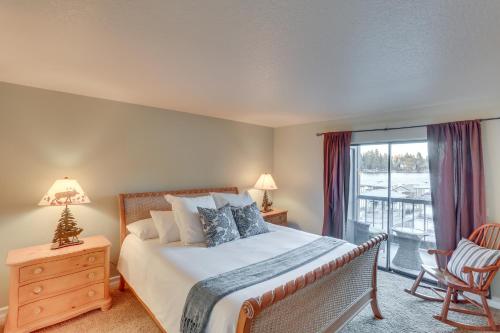 a bedroom with a bed and a window with a balcony at Waterfront Lake Arrowhead Townhome with Balconies! in Lake Arrowhead
