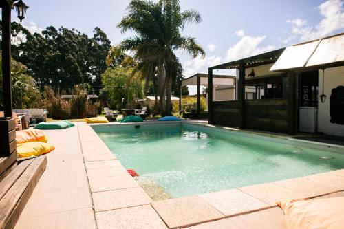 a swimming pool in the backyard of a house at La Quinta Hostel & Suites in Punta del Este