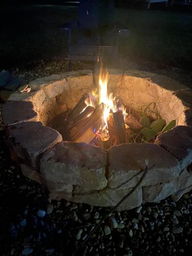 a fire burns in a stone fire pit at night at Rancho Alegre. Bring your boat and RV too! in Clewiston