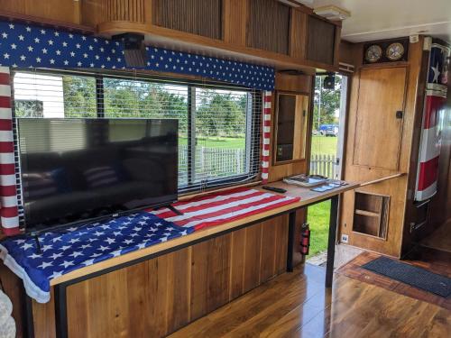 an inside view of an rv with a tv and a large window at 'Arvey the American RV in Haxey