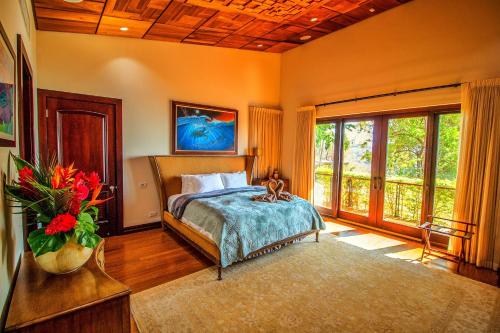 a bedroom with a bed and a large window at Casa Rosen Ocean View Villa in Nacascolo