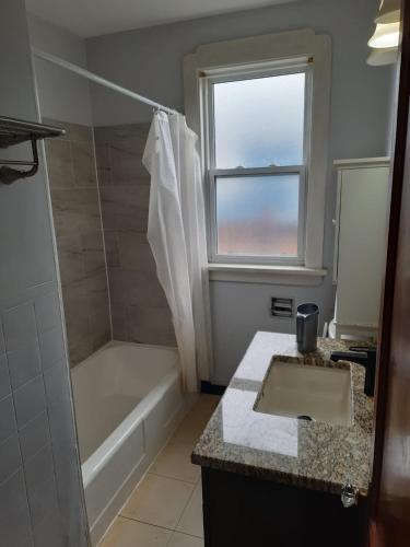 a bathroom with a tub and a sink and a shower at House -1 in Thunder Bay