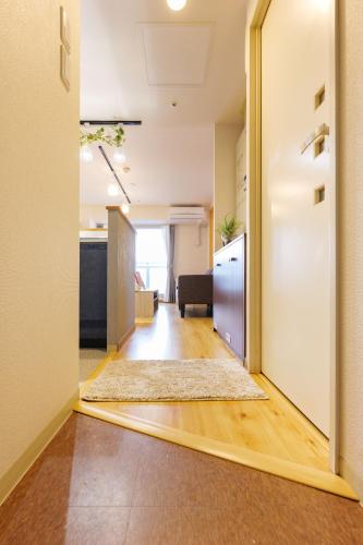 an empty hallway with an open door to a kitchen at Nakajima Park stay AMS tower Nakajima 16F in Sapporo