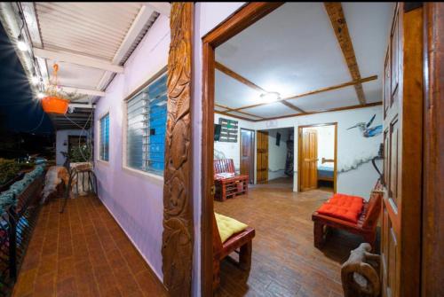 a living room with a couch and chairs in a room at Boho by Arte Hostal Boquete in Bajo Boquete