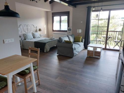 a living room with a couch and a table at Apartamentos Casa Reconco in Luanco