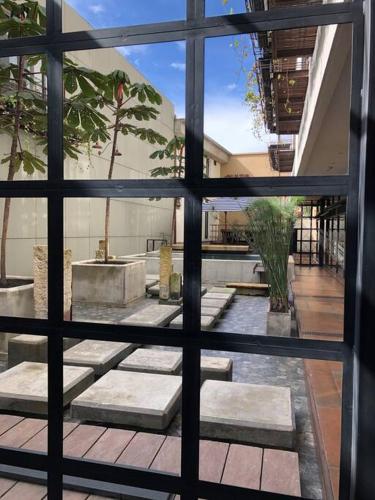 a view of a courtyard through a window at La Primera en La Candelaria in Bogotá