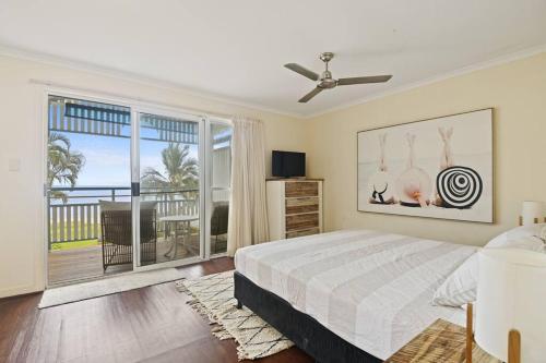 a bedroom with a bed and a large window at Tangalooma Beachfront Villa 23 2 bedroom in Tangalooma