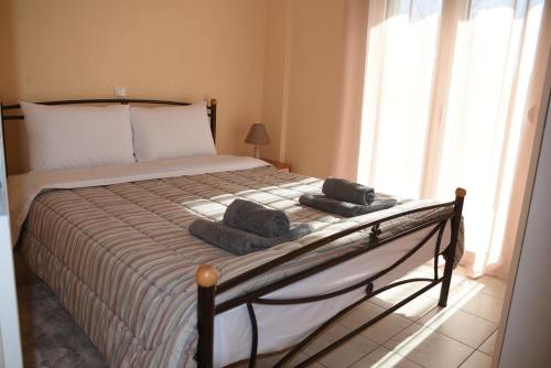 a bedroom with a large bed with towels on it at VILLAGE HOUSE in Tríkala