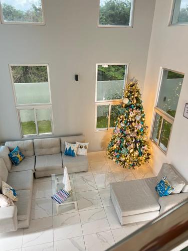 a living room with a christmas tree and a couch at 5 Star Villa minutes from Airport and Beaches in Sosúa