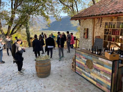 a group of people walking around a wine barrel at Sad Meli Wines in Ambrolauri