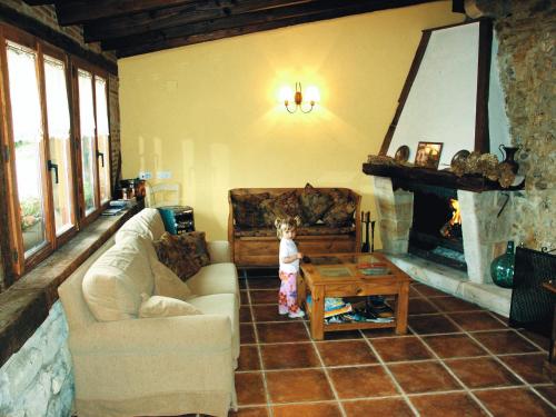 ein Kind steht in einem Wohnzimmer mit Kamin in der Unterkunft Aristieta in Ajangiz