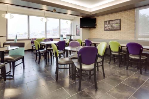 a dining room with tables and chairs and windows at Drury Inn & Suites San Antonio Northeast in San Antonio